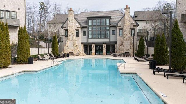 pool featuring a patio area and fence