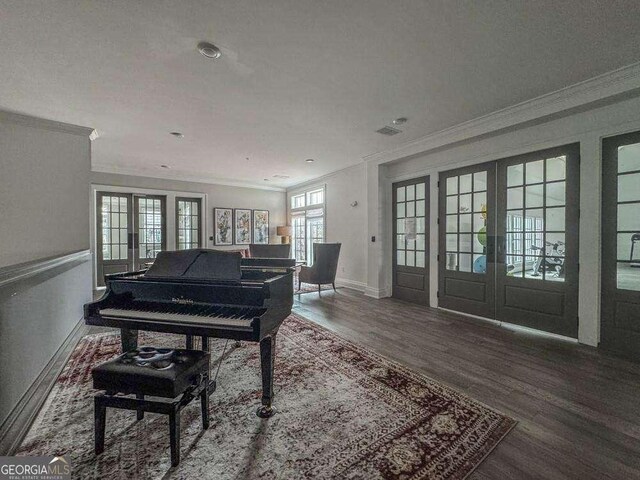interior space with crown molding, french doors, and wood finished floors
