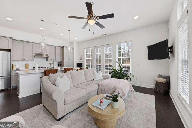 living room with recessed lighting, baseboards, ceiling fan, and dark wood-style flooring