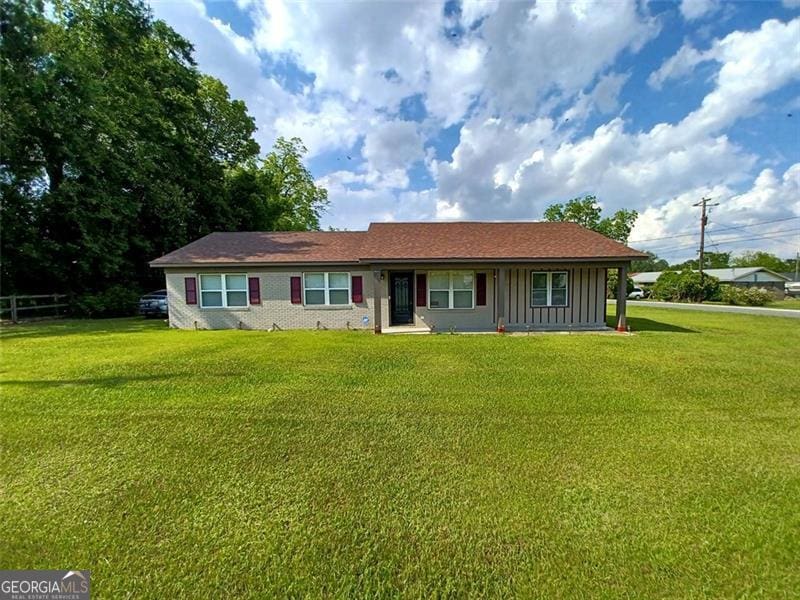 view of front of house featuring a front lawn and board and batten siding
