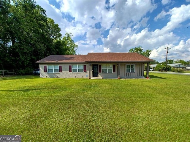 view of front of house featuring a front lawn and board and batten siding