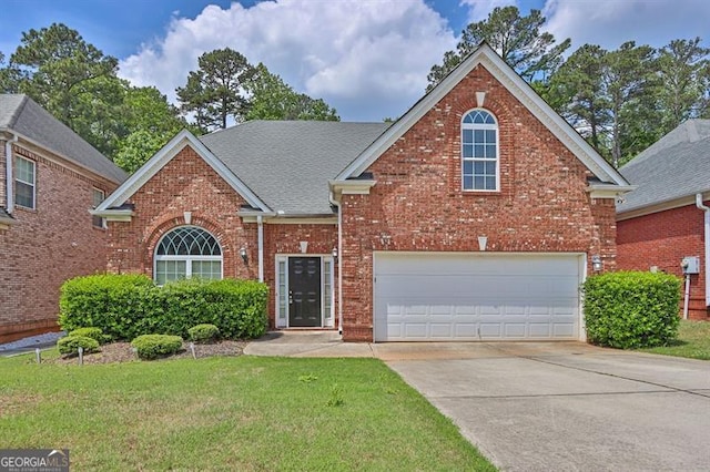735 Scenic Creek Dr, Lawrenceville, GA 30046 - traditional-style house with driveway, brick siding, a front lawn, and a garage