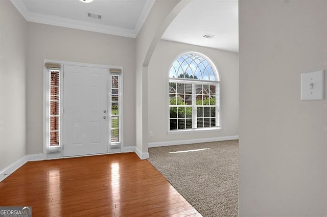 735 Scenic Creek Dr, Lawrenceville, GA 30046 - foyer featuring arched walkways, crown molding, and wood-type flooring