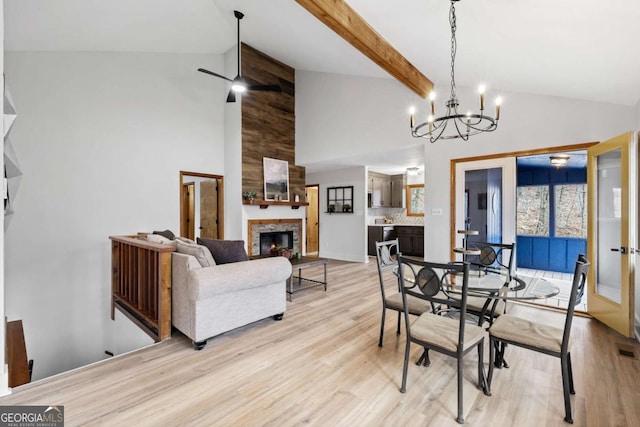 49 Baum Weg, Helen, GA 30545 - dining space featuring a large fireplace, beamed ceiling, light wood-type flooring, and high vaulted ceiling