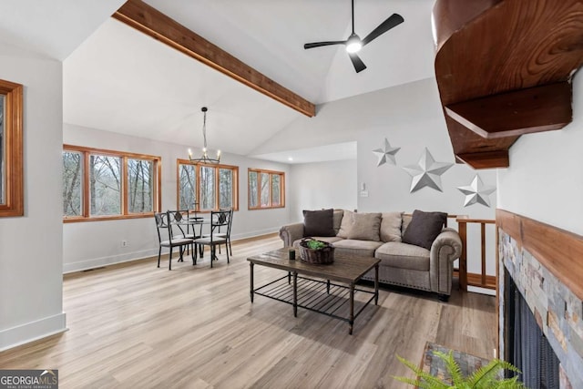 49 Baum Weg, Helen, GA 30545 - living room featuring a fireplace, baseboards, lofted ceiling with beams, light wood finished floors, and ceiling fan with notable chandelier