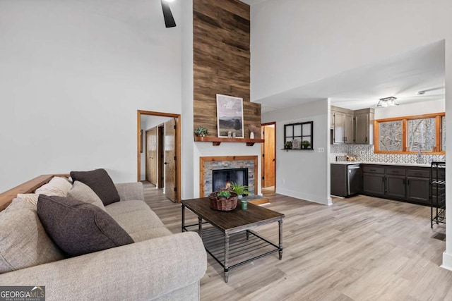 49 Baum Weg, Helen, GA 30545 - living area featuring a high ceiling, light wood-type flooring, and a fireplace