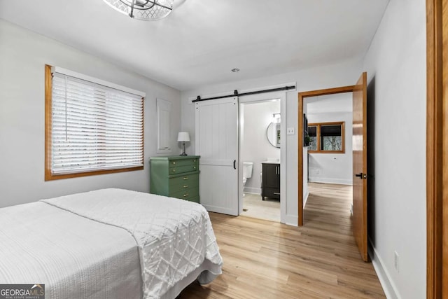 49 Baum Weg, Helen, GA 30545 - bedroom with baseboards, light wood-style flooring, and a barn door
