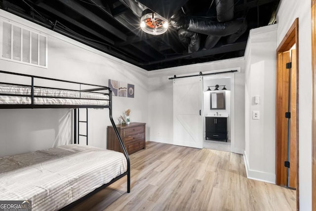 49 Baum Weg, Helen, GA 30545 - bedroom with visible vents, a barn door, baseboards, and wood finished floors