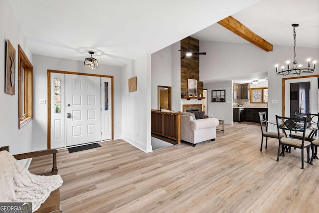49 Baum Weg, Helen, GA 30545 - foyer with lofted ceiling with beams, light wood-style flooring, a chandelier, and a large fireplace
