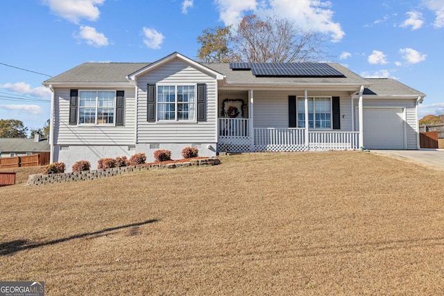 view of front facade featuring a garage, a porch, a front yard, roof mounted solar panels, and crawl space