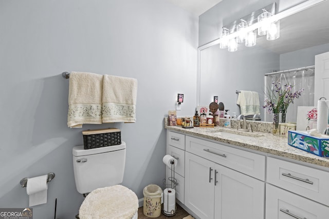bathroom with vanity, a shower with shower curtain, and toilet