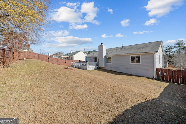 rear view of property with a lawn, a fenced backyard, and crawl space