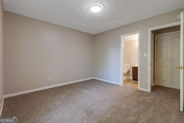 785 Redland Dr, Jonesboro, GA 30238 - unfurnished bedroom featuring carpet floors, a textured ceiling, and ensuite bath