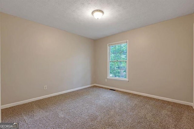 785 Redland Dr, Jonesboro, GA 30238 - carpeted empty room featuring a textured ceiling and baseboards