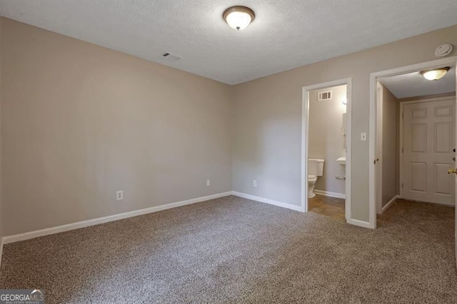 785 Redland Dr, Jonesboro, GA 30238 - unfurnished bedroom with carpet, a textured ceiling, and ensuite bathroom