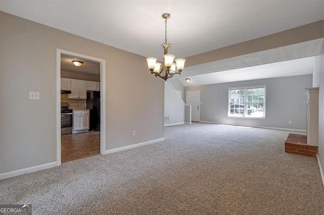 785 Redland Dr, Jonesboro, GA 30238 - carpeted empty room with baseboards and a chandelier