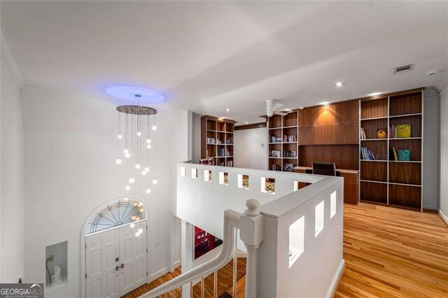 dining room featuring light wood-style floors, ceiling fan, and crown molding