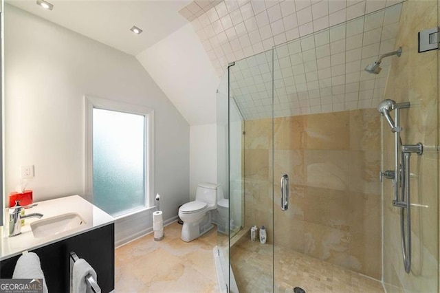 full bath featuring toilet, vaulted ceiling, a stall shower, vanity, and baseboards
