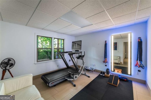 workout area with a drop ceiling and baseboards
