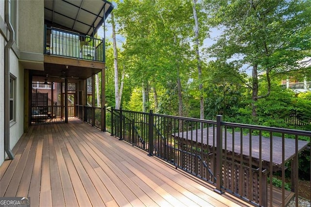 wooden deck with view of scattered trees
