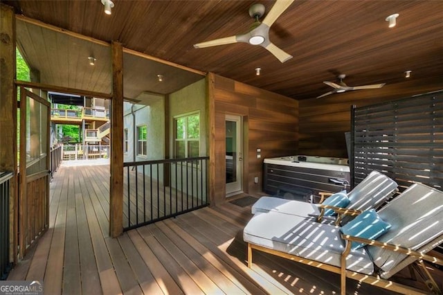 wooden deck with a ceiling fan