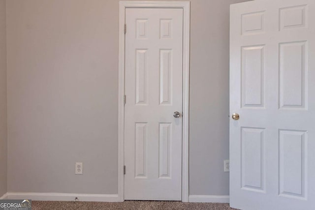 unfurnished bedroom featuring baseboards and carpet