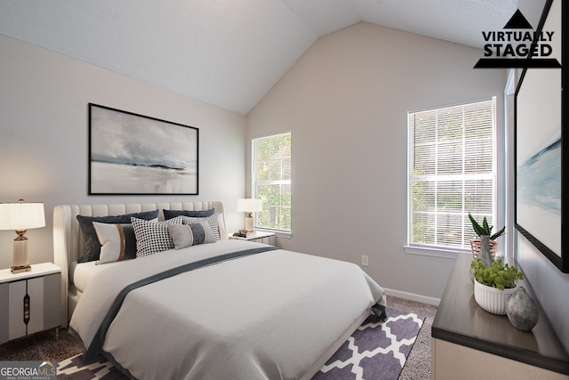 carpeted bedroom featuring vaulted ceiling, multiple windows, and baseboards