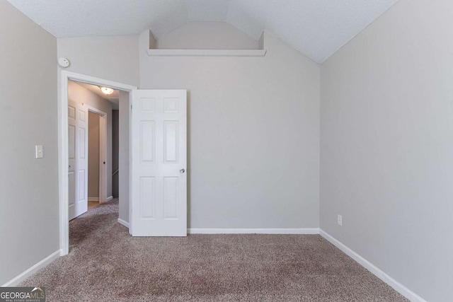 2319 Rambling Way, Lithonia, GA 30058 - unfurnished bedroom with vaulted ceiling and carpet flooring