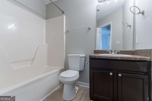 full bath featuring toilet, washtub / shower combination, vanity, and baseboards