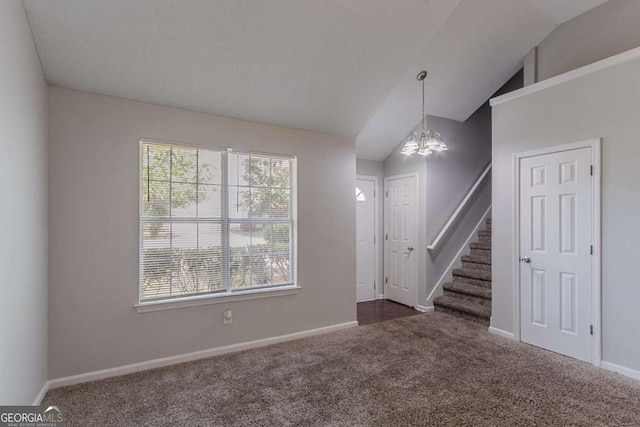 2319 Rambling Way, Lithonia, GA 30058 - foyer with a chandelier, dark colored carpet, vaulted ceiling, and stairs