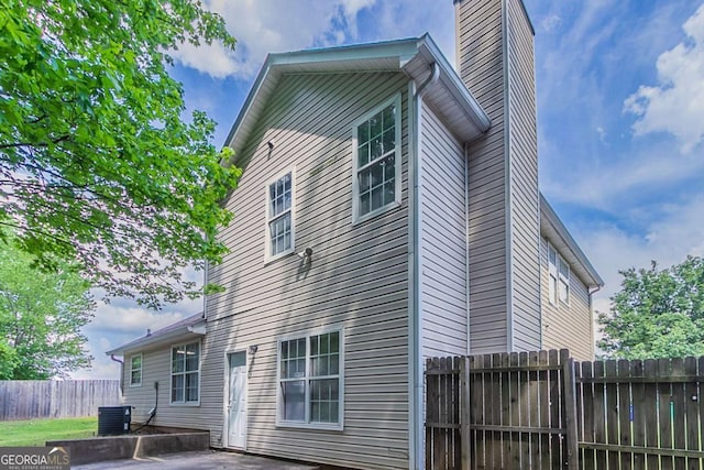 2319 Rambling Way, Lithonia, GA 30058 - back of property with a patio area and a chimney
