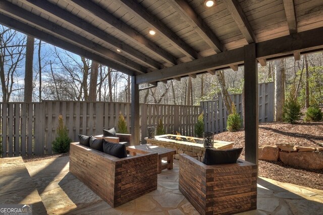 view of patio with a fenced backyard and a fire pit