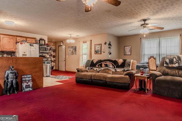 living room with a textured ceiling, ceiling fan, and light colored carpet
