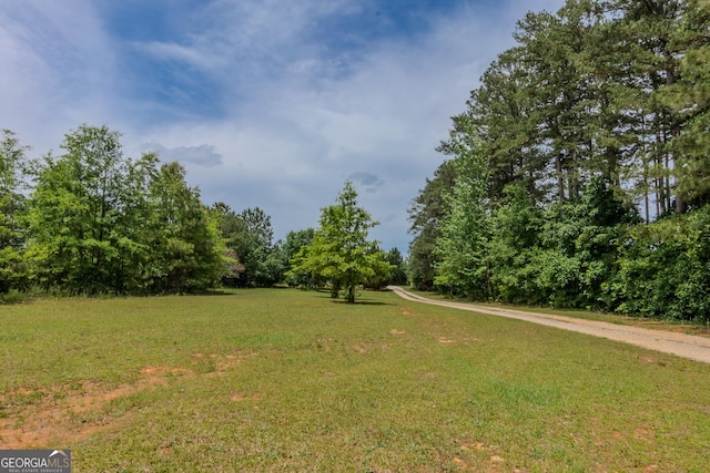 view of property's community with a lawn