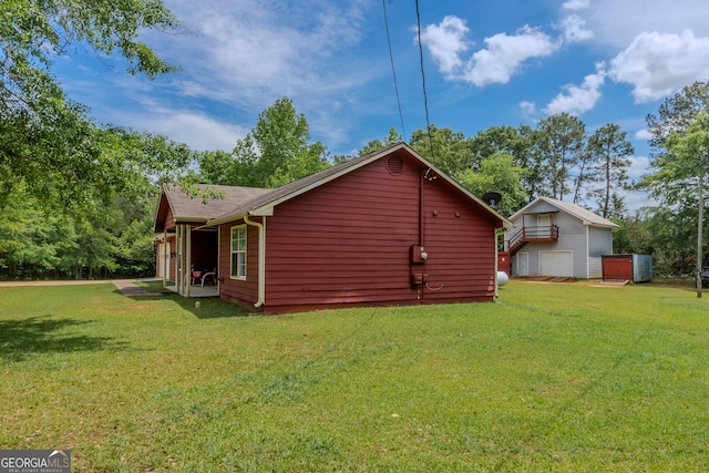 view of home's exterior featuring a lawn and a shingled roof