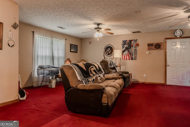 carpeted living room with visible vents, a ceiling fan, baseboards, and a textured ceiling