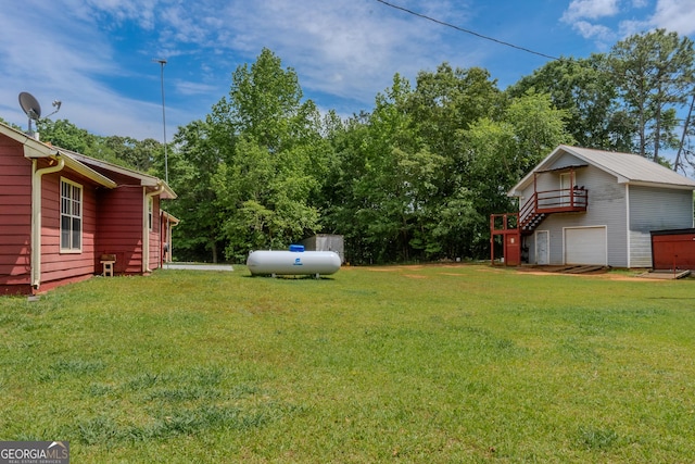 view of yard with stairs and a garage