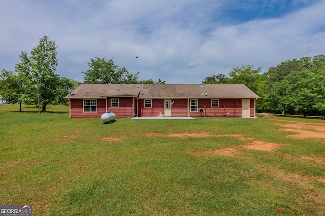 rear view of property with a patio area and a yard