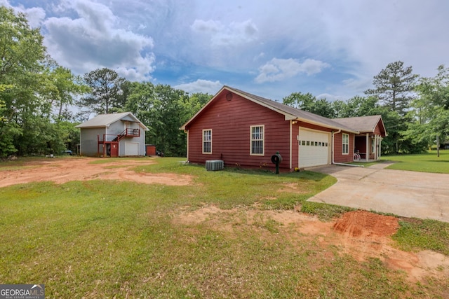 1170 Peeksville Rd, Locust Grove, GA 30248 - view of side of property featuring central air condition unit, an attached garage, a yard, and driveway