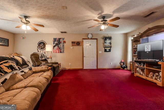 carpeted living area with ceiling fan, a textured ceiling, and visible vents