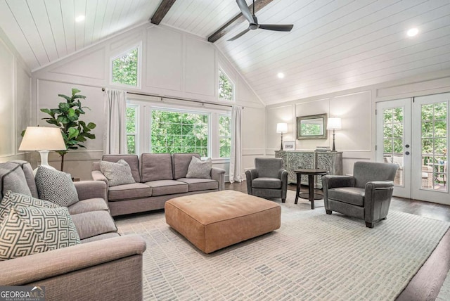 living room featuring wood finished floors, a decorative wall, beamed ceiling, ceiling fan, and high vaulted ceiling
