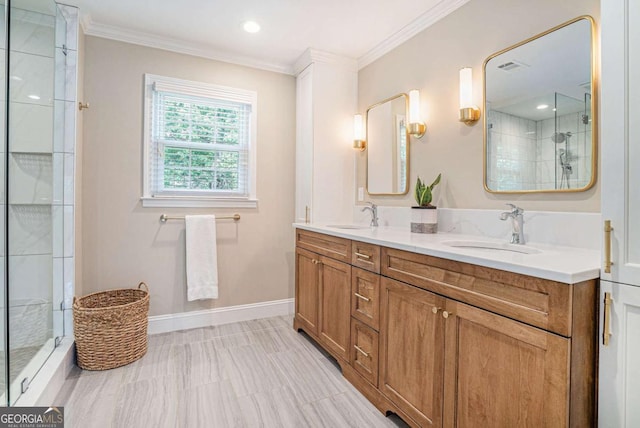 bathroom with double vanity, ornamental molding, a shower stall, and a sink