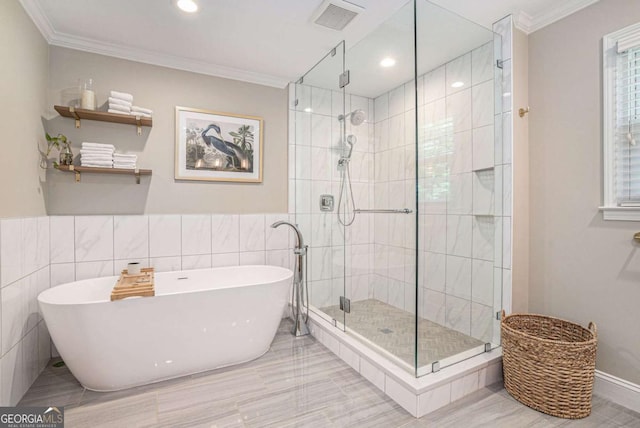 full bath featuring ornamental molding, a stall shower, a soaking tub, and tile walls