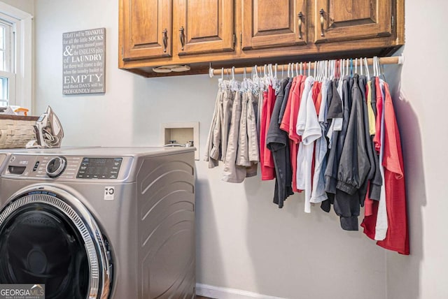 washroom featuring cabinet space and washer / clothes dryer