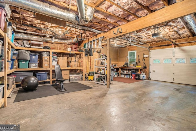 garage with a workshop area and a garage door opener