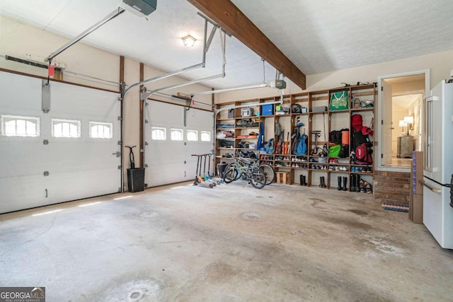 garage featuring high end white refrigerator and a garage door opener