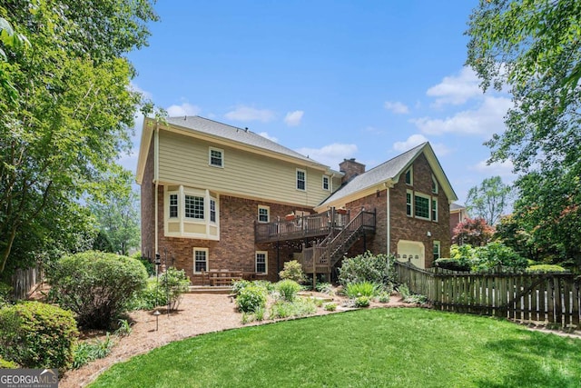 back of house featuring fence, brick siding, an attached garage, a yard, and stairway
