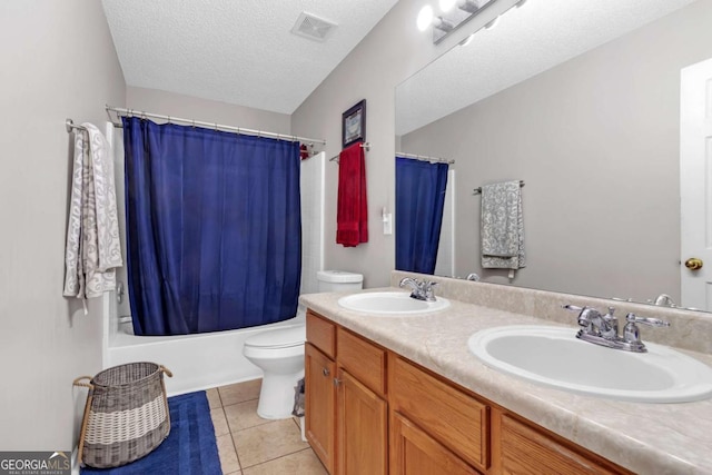bathroom with toilet, tile patterned floors, visible vents, and a sink