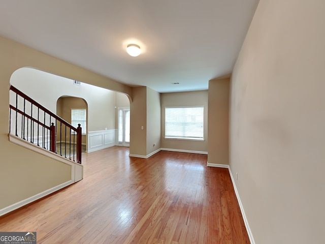 4140 Butternut Pl, South Fulton, GA 30349 - spare room with arched walkways, hardwood / wood-style floors, and stairway