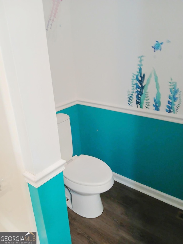 bathroom with toilet and wood finished floors